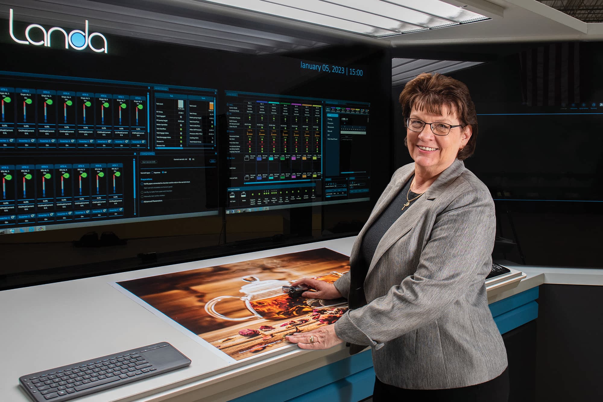CEO of Quantum Group Cheryl Kahanec in front of Landa digital printing press